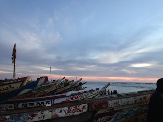 Sunset over the Senegal River with traditional pirogues floating gently.