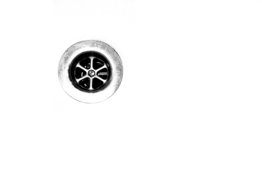 round silver-colored wheel in white background