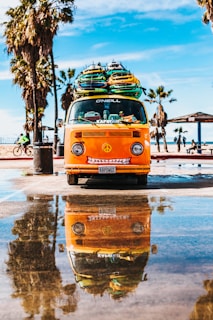 orange van with surfboard on top