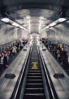 people riding escalator