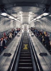 people riding escalator