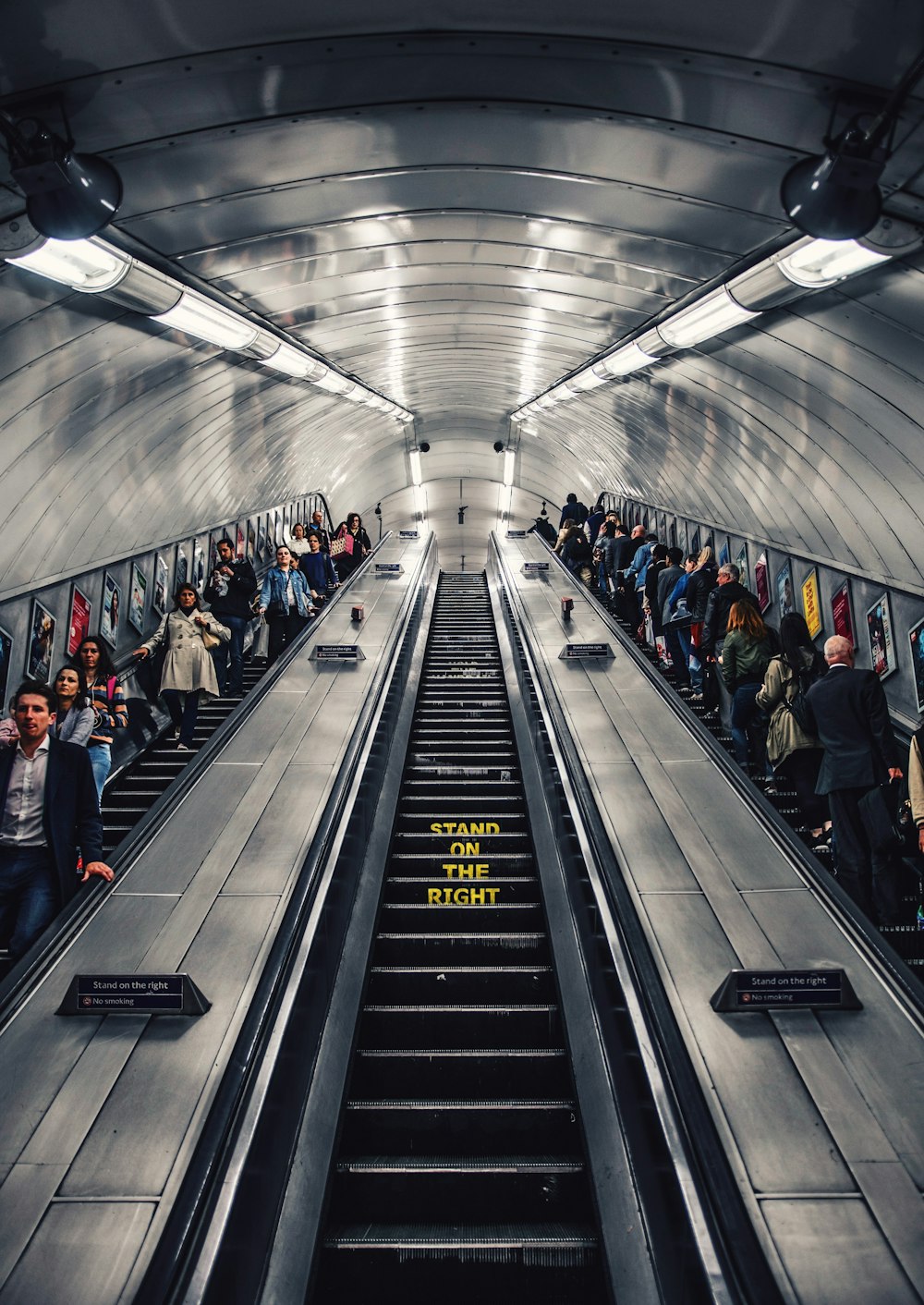 people riding escalator