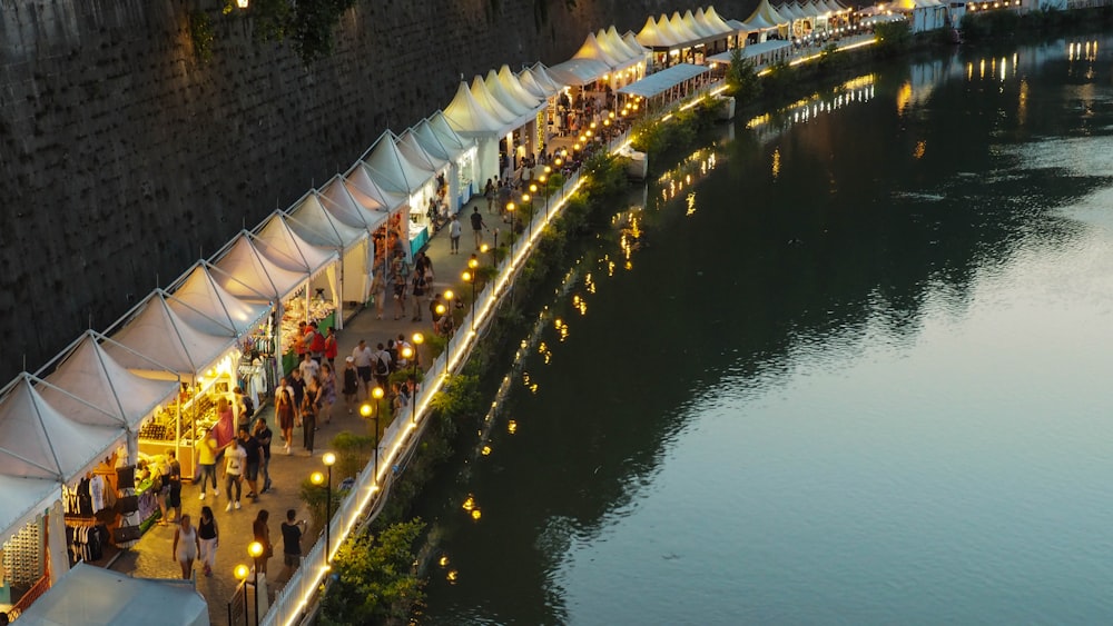 white canopy with stores near body of water during daytime