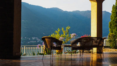 A serene outdoor patio with seating overlooking the rugged Muscat mountains.