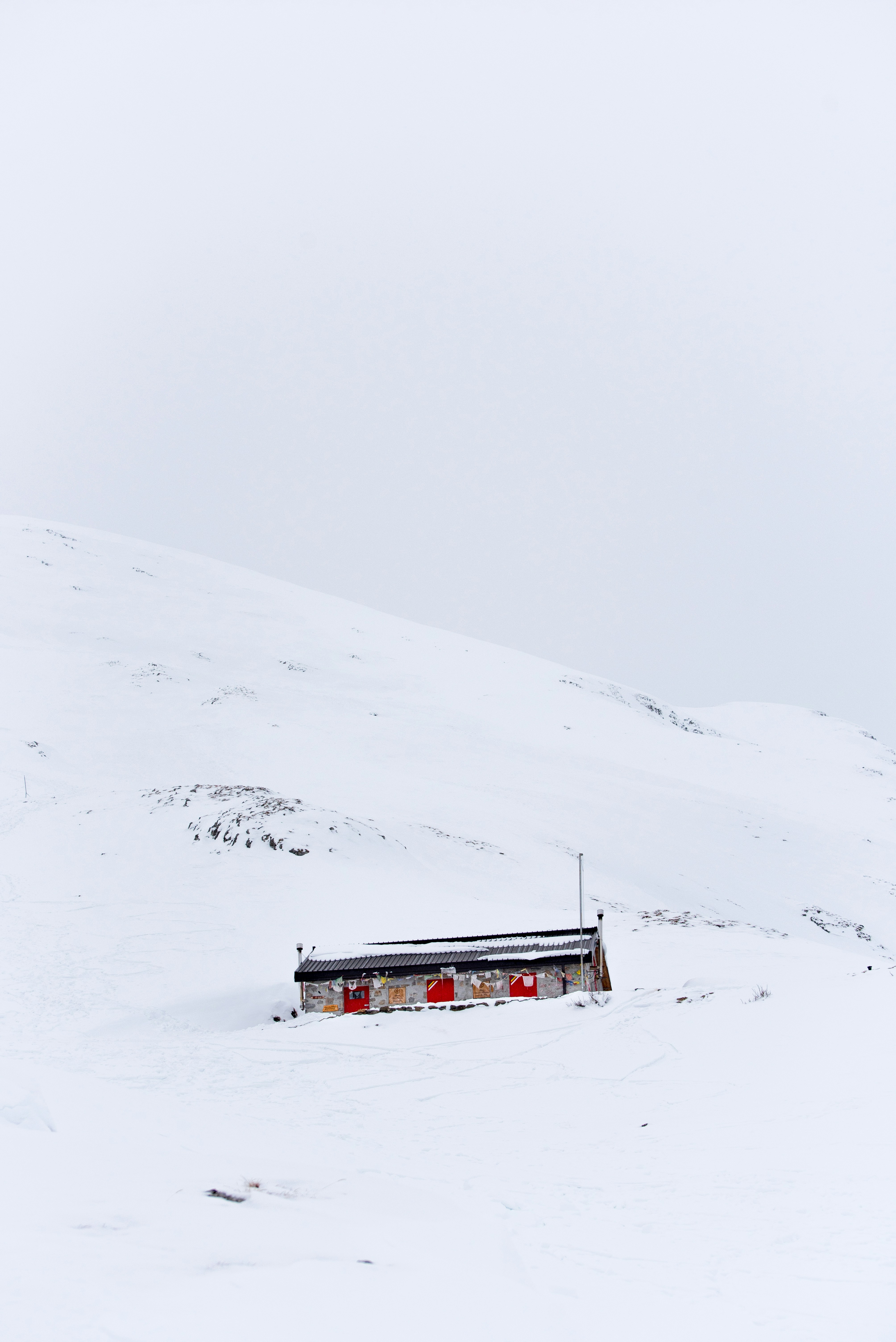gray house surrounded snow mountain