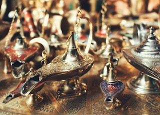 selective focus photo of gold-colored oil lamps