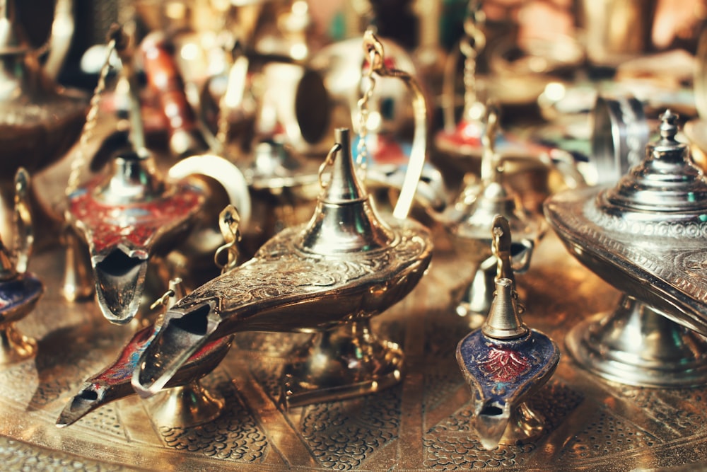 selective focus photo of gold-colored oil lamps