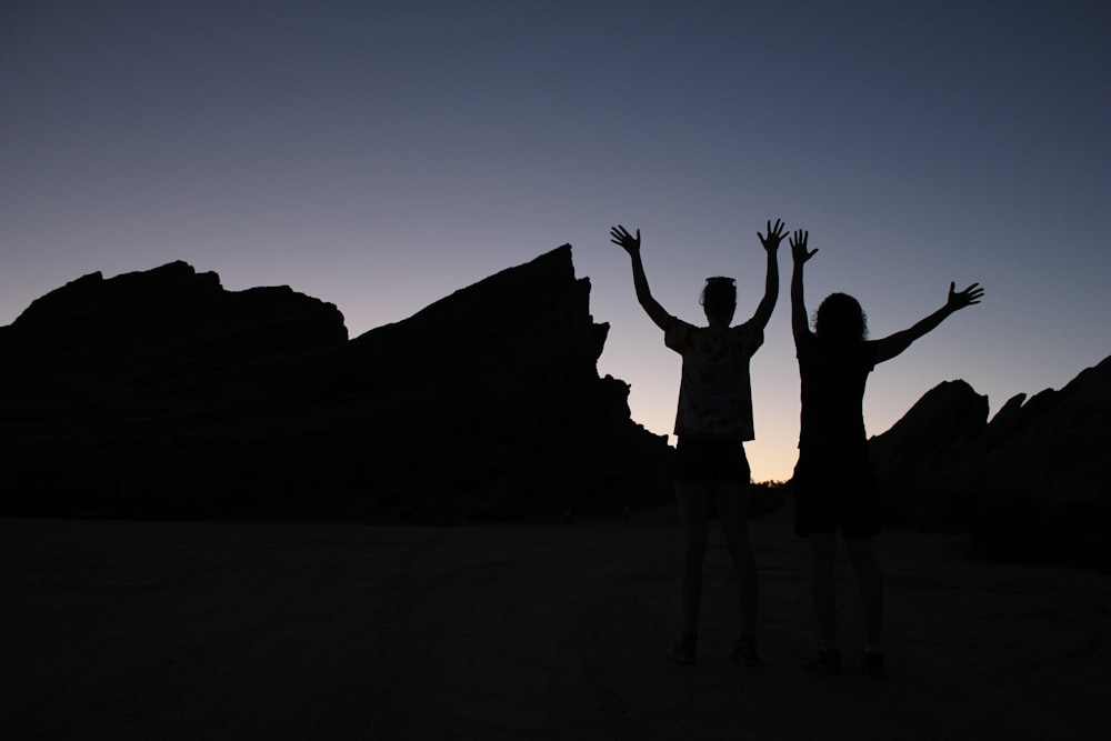 two people standing on field under gray sky during daytime