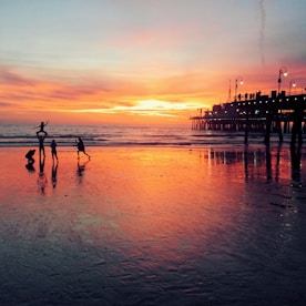 silhouette of people at the seashore