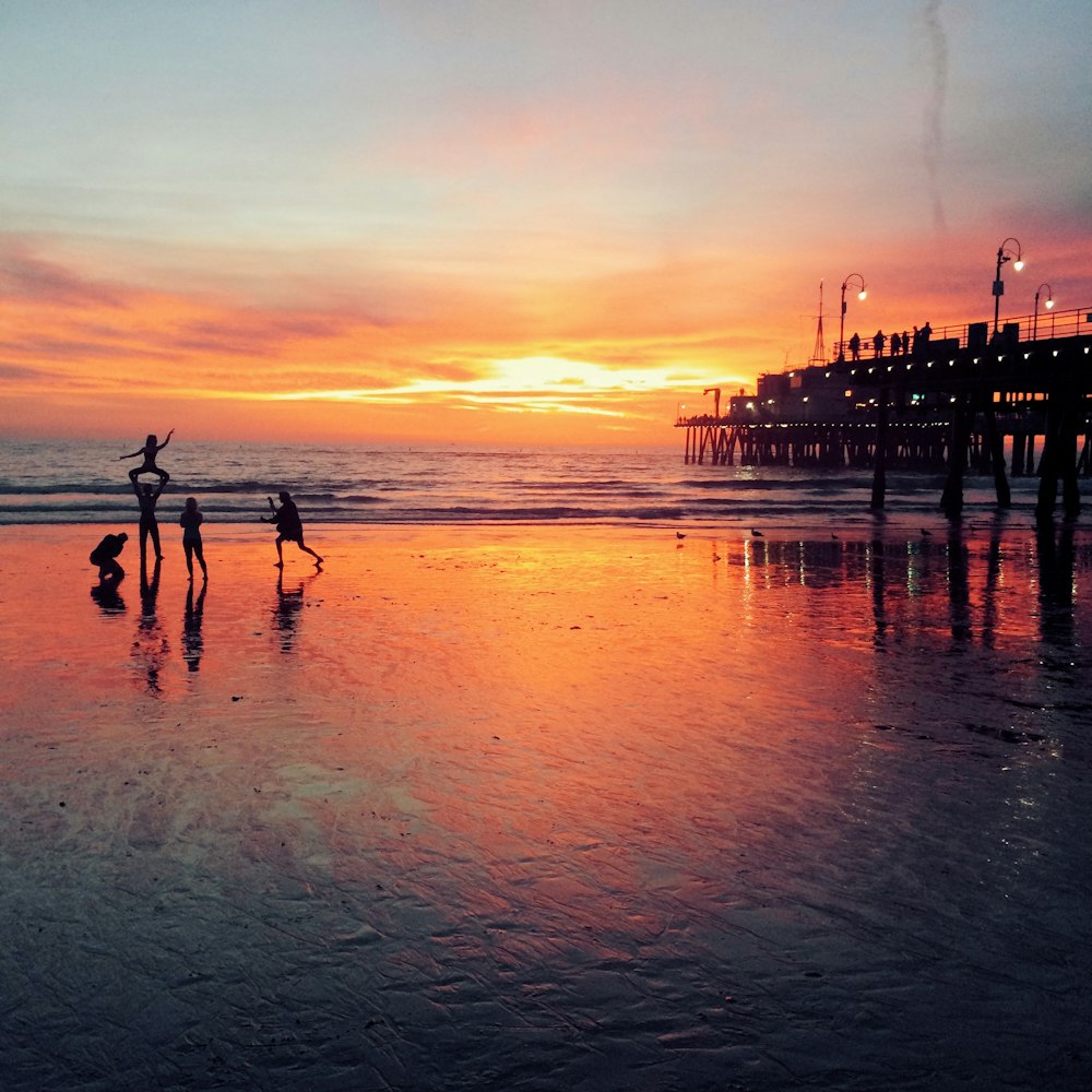 silhouette of people at the seashore