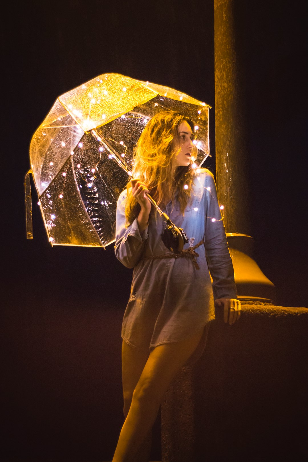 Woman with lighted umbrella.
