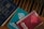 A group of religious books resting on a wooden surface. The blue book is a Holy Bible, while two spiral-bound books titled 'Scripture in Song' in teal and red are nearby, labeled as Book Two and Book One, respectively. The books have a vintage appearance.