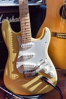 brown and white electric guitar