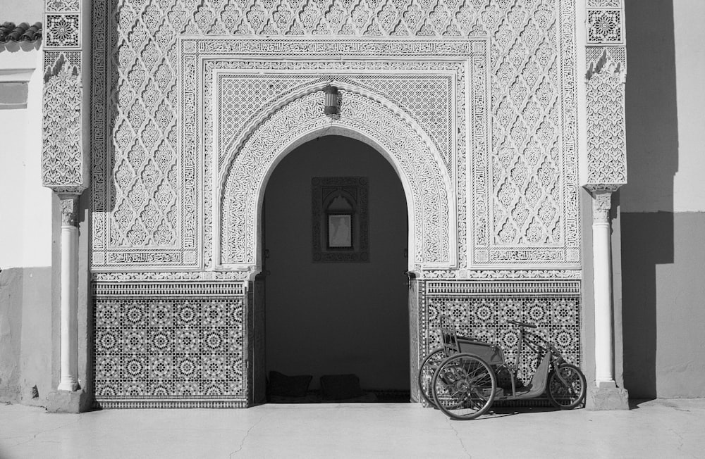 gray trike infront of white concrete house