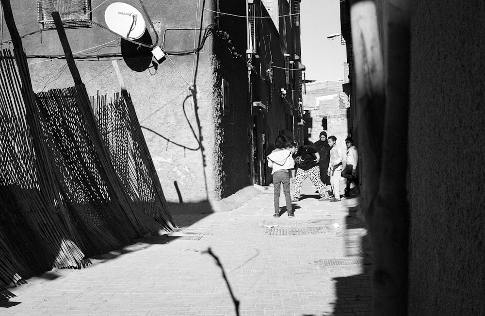 four person standing near wall