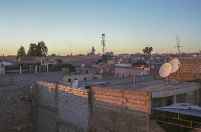 A scenic view of Marrakech skyline at sunset highlighting residential buildings and vibrant streets.