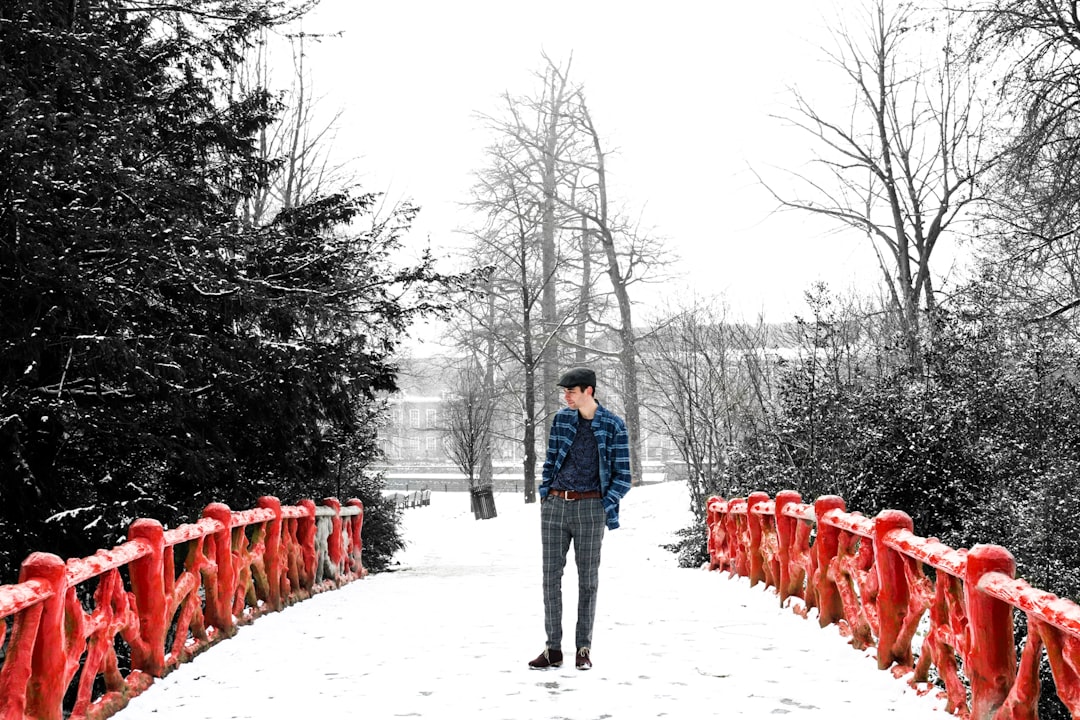 man standing in red bridge