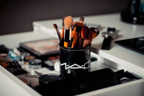 A set of professional makeup brushes arranged on a vanity.