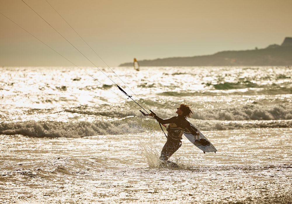 person doing wind surfing on body of water