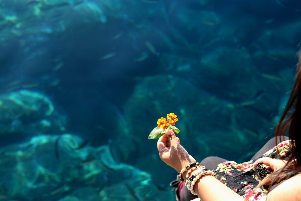 woman holding yellow flowers