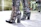 A pair of black platform boots with silver buckles displayed on a vintage wooden floor.
