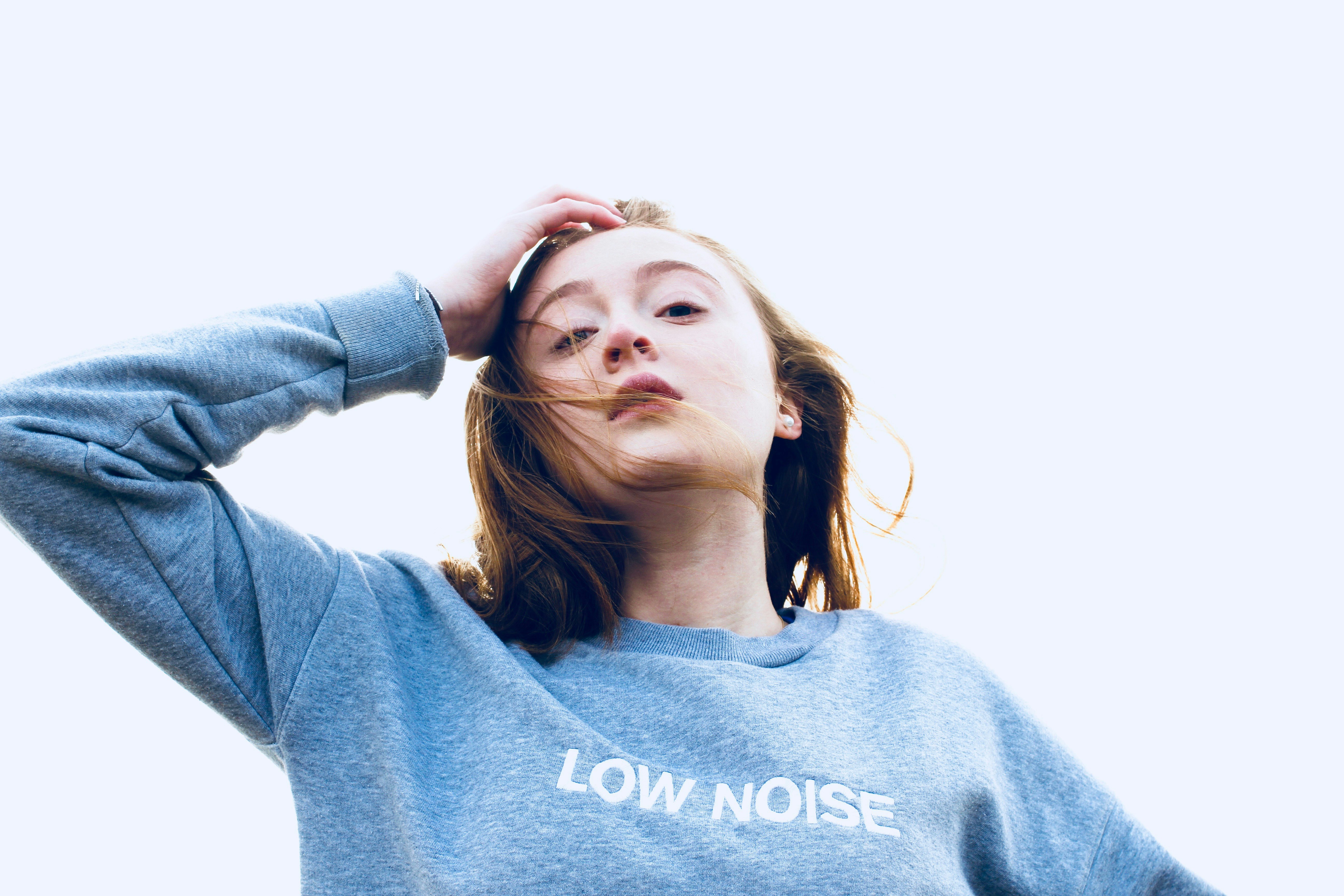 woman wearing blue long-sleeved top