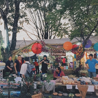 A vibrant photo capturing a lively street market bustling with colorful stalls and happy visitors.