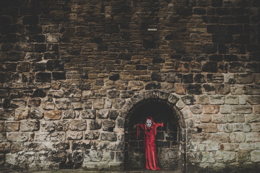 red coat on wall brick