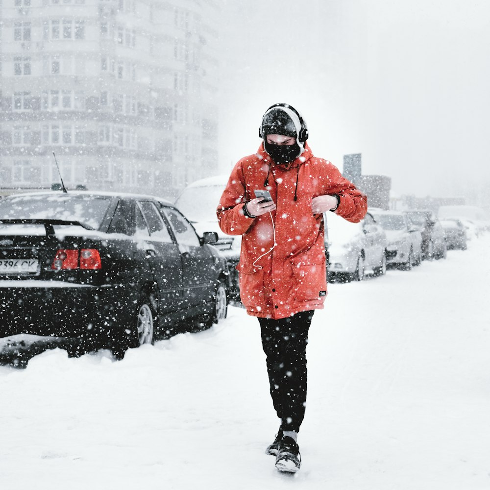 man walking on snowy road