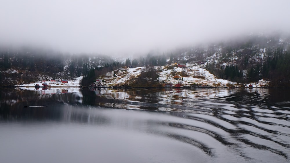 island covered by fog near water