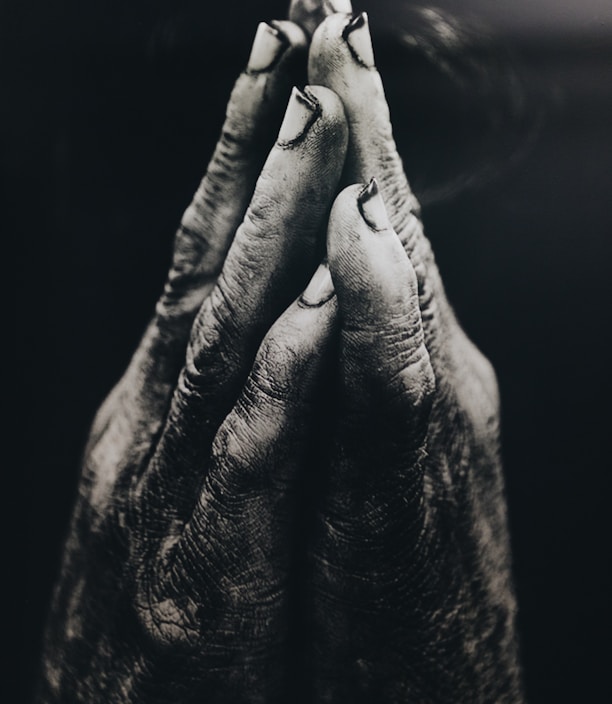 grayscale photography of praying hands