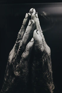 grayscale photography of praying hands