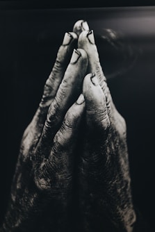 grayscale photography of praying hands