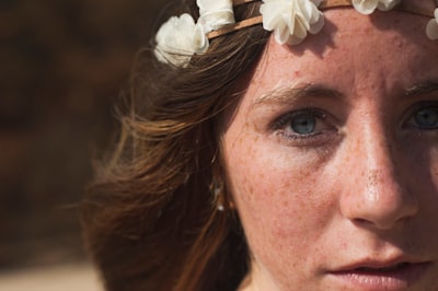 portrait photo of woman wearing floral crown blue-eyed google meet background