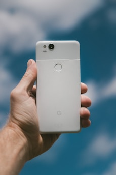 person holding white Google Android smartphone