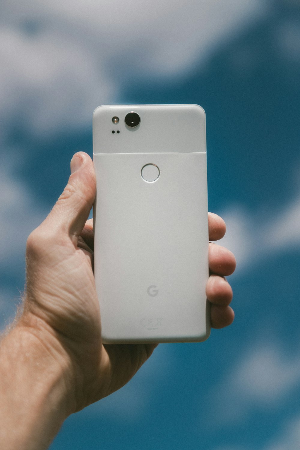 person holding white Google Android smartphone