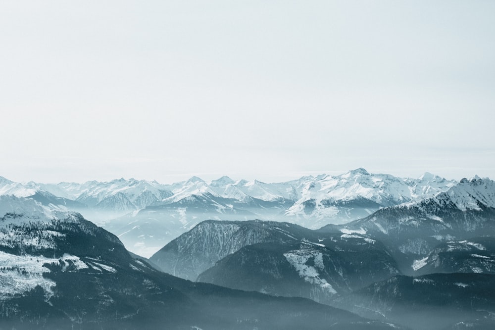 ice covered mountain covered with fog during daytime