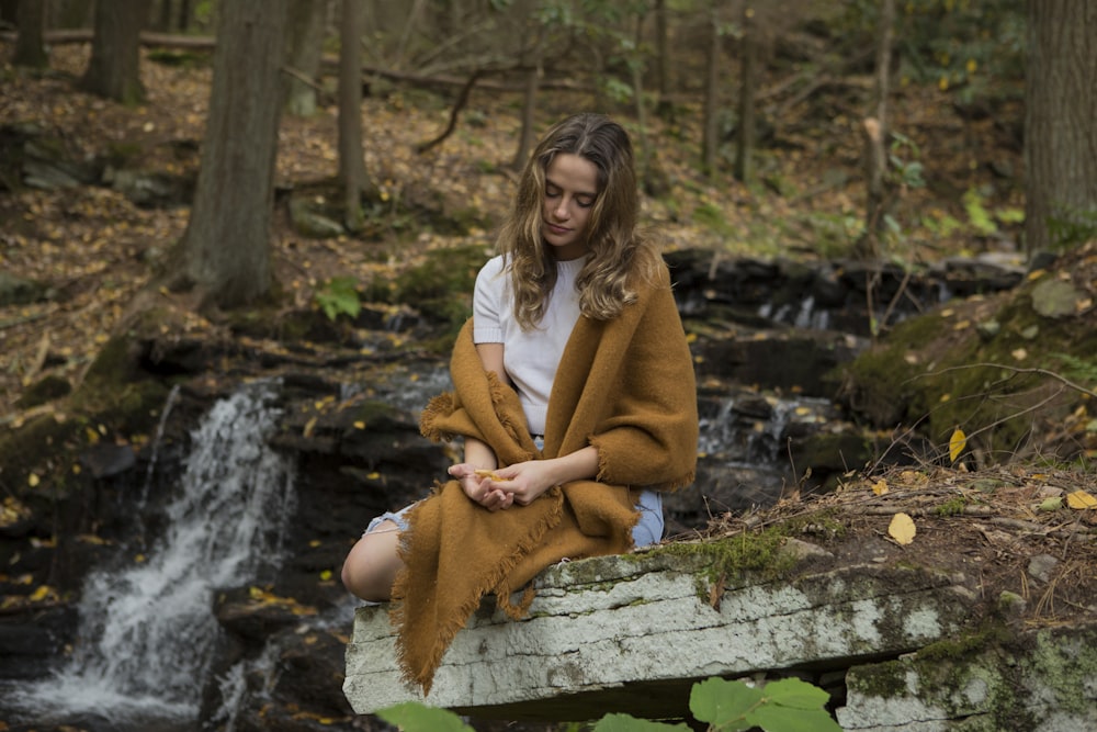 woman meditating on forest