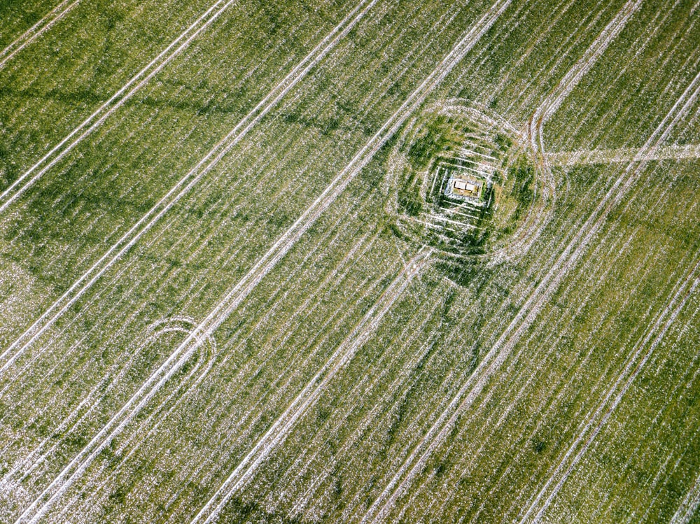 an aerial view of a field with a circular object in the middle of it