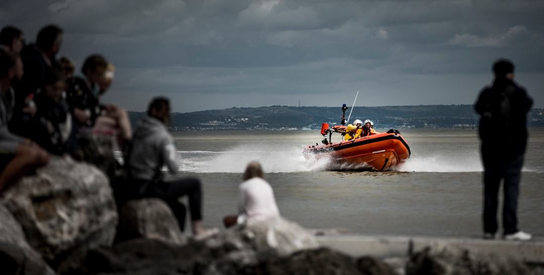 group of people looking at the speedboat on sea