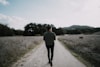 man walking on empty road