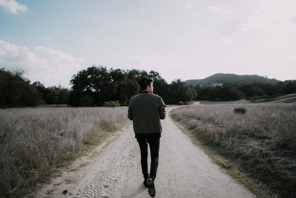 man walking on empty road