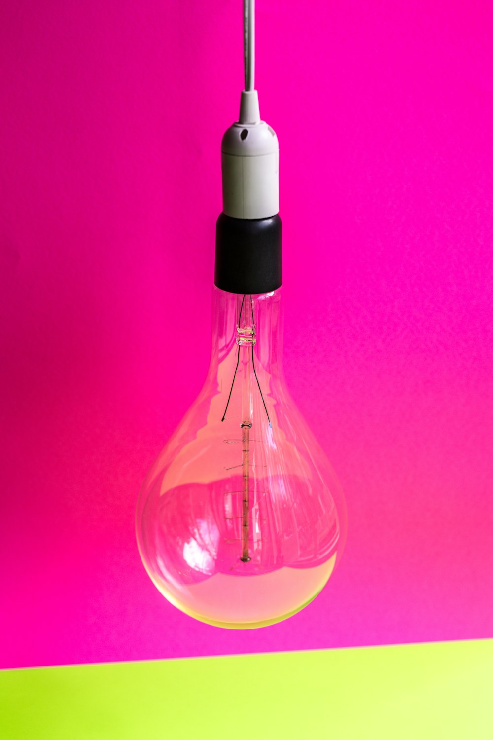 close-up photo of light bulb with pink background