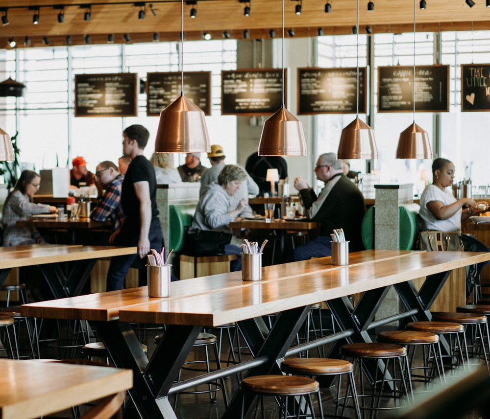 group of people eating inside cafeteria