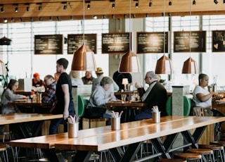 group of people eating inside cafeteria