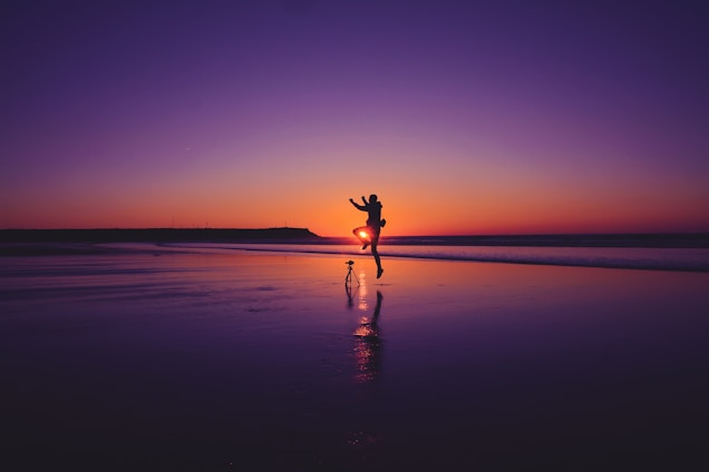 A happy couple enjoying a scenic Brazilian beach at sunset, symbolizing personalized travel experiences.