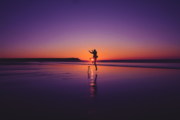 Happy couple enjoying a scenic sunset on a tropical beach.