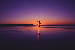 A couple enjoying a romantic dinner by the beach.