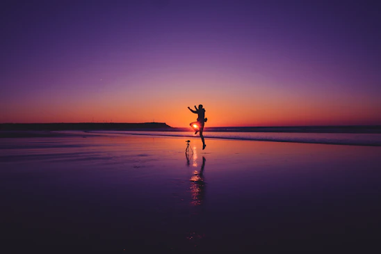 A joyful couple enjoying a private beach sunset in the Mexican Caribbean.