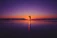 Romantic couple enjoying a sunset on an exotic international beach